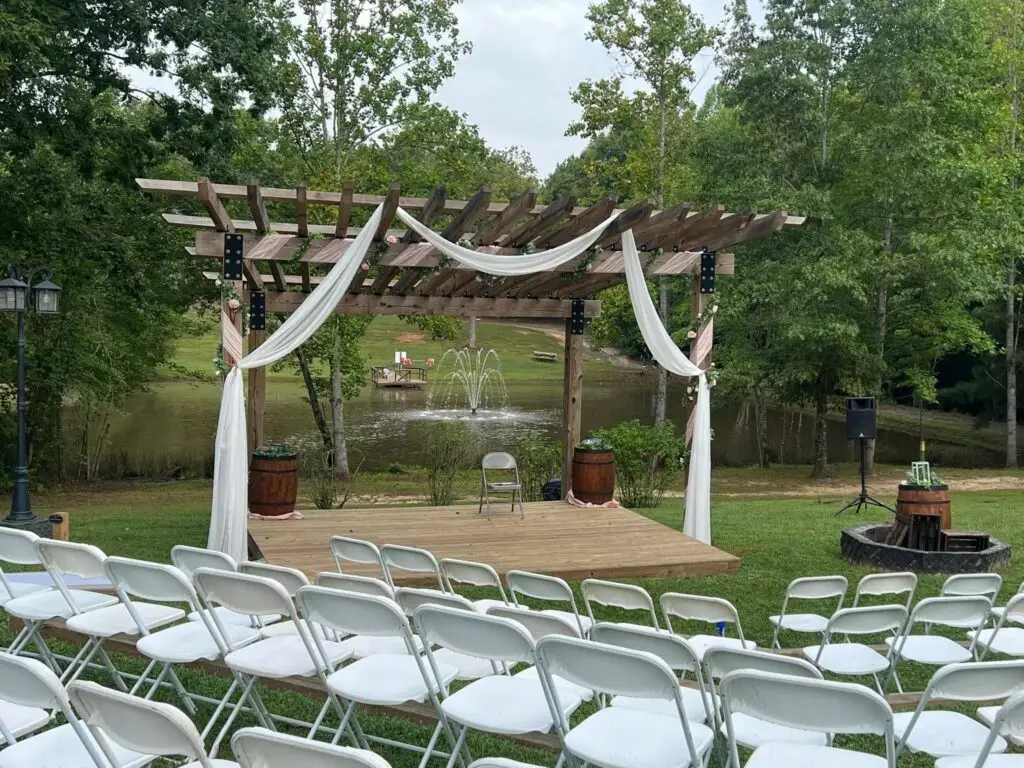 Lakeside Garden Chapel set up with white chairs for an outdoor wedding