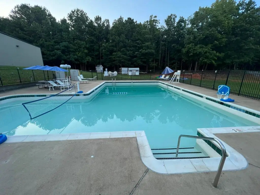 Swimming pool with lounge chairs on a summer day