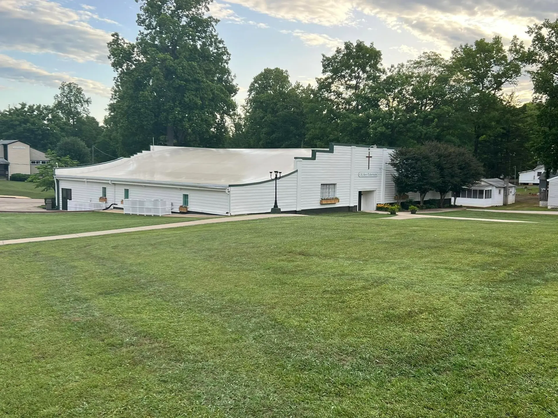 White campus buildings across an open lawn